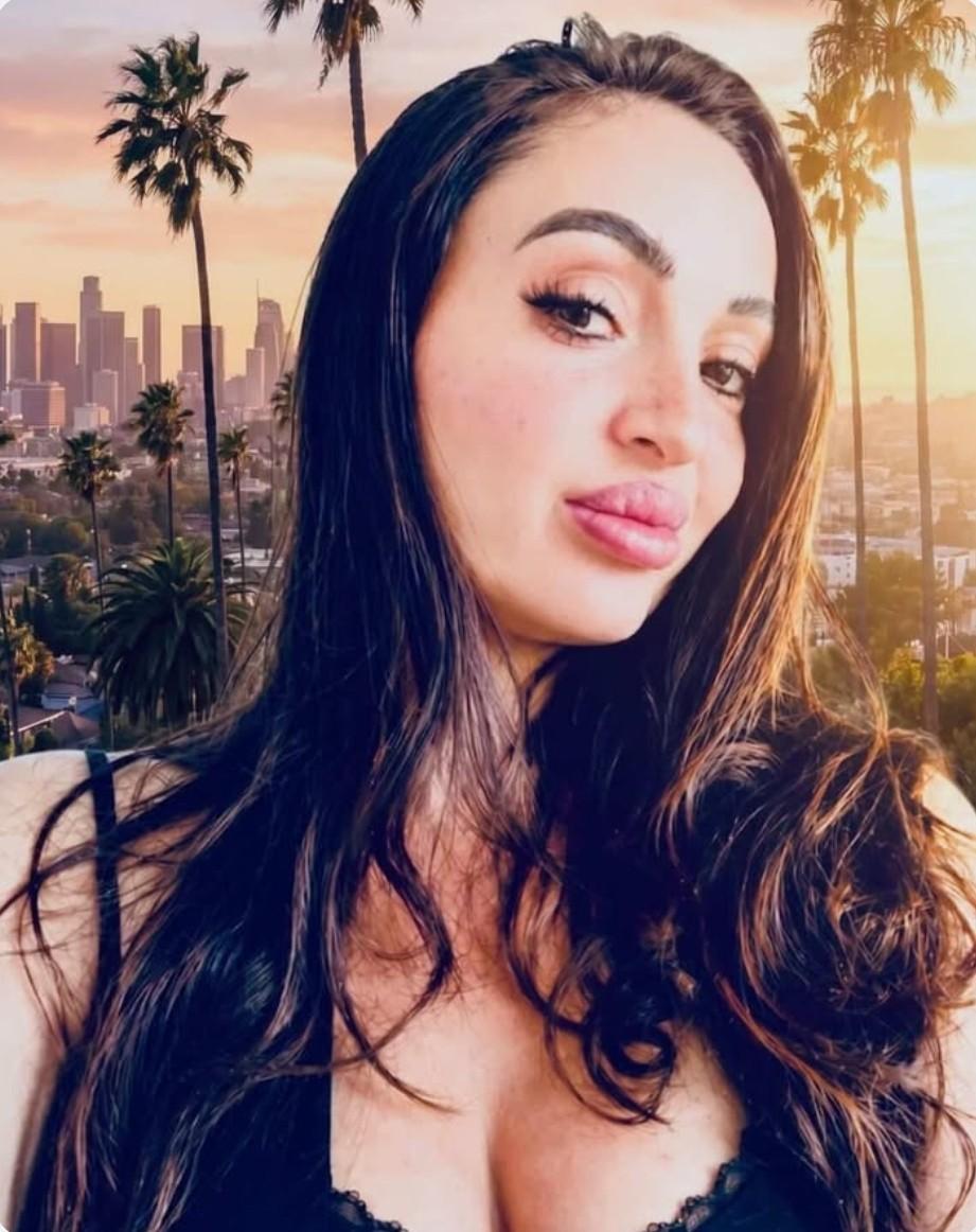 Alana McKanion close-up portrait with Los Angeles skyline background emerging author and cultural figure