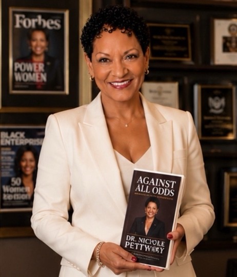 Dr. Nichole Pettway holding her memoir Against All Odds, highlighting resilience, leadership, and social impact