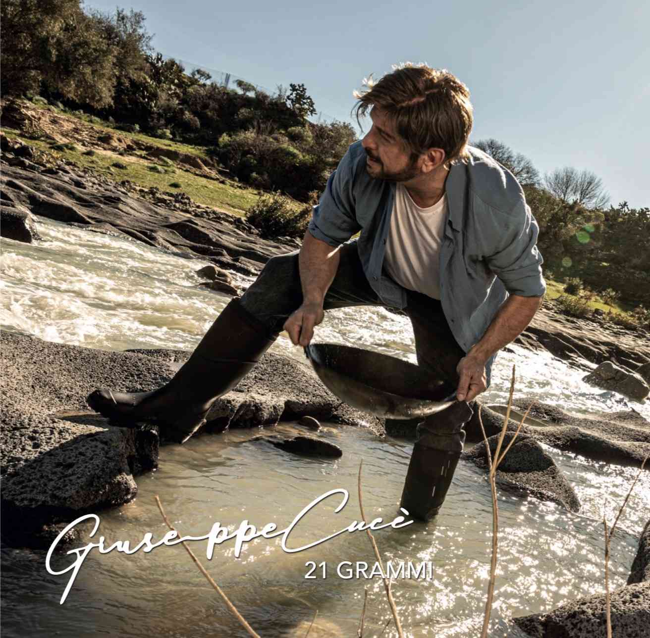 Giuseppe Cucè photographed in a river landscape for his concept album 21 Grammi inspired by cinematic emotion and Italian artistry