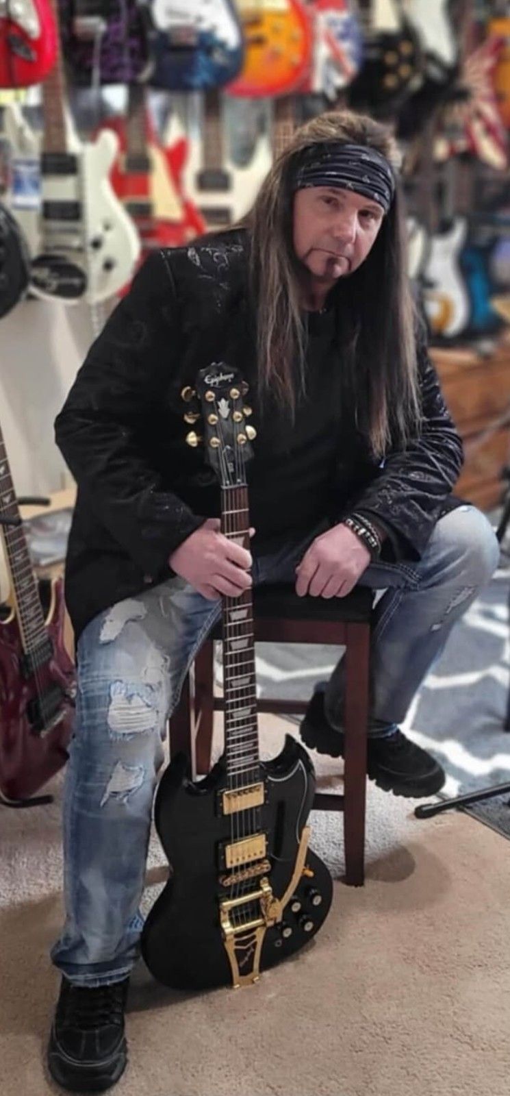 JJ Tyson with electric guitar in music studio outlaw southern metal artist and songwriter